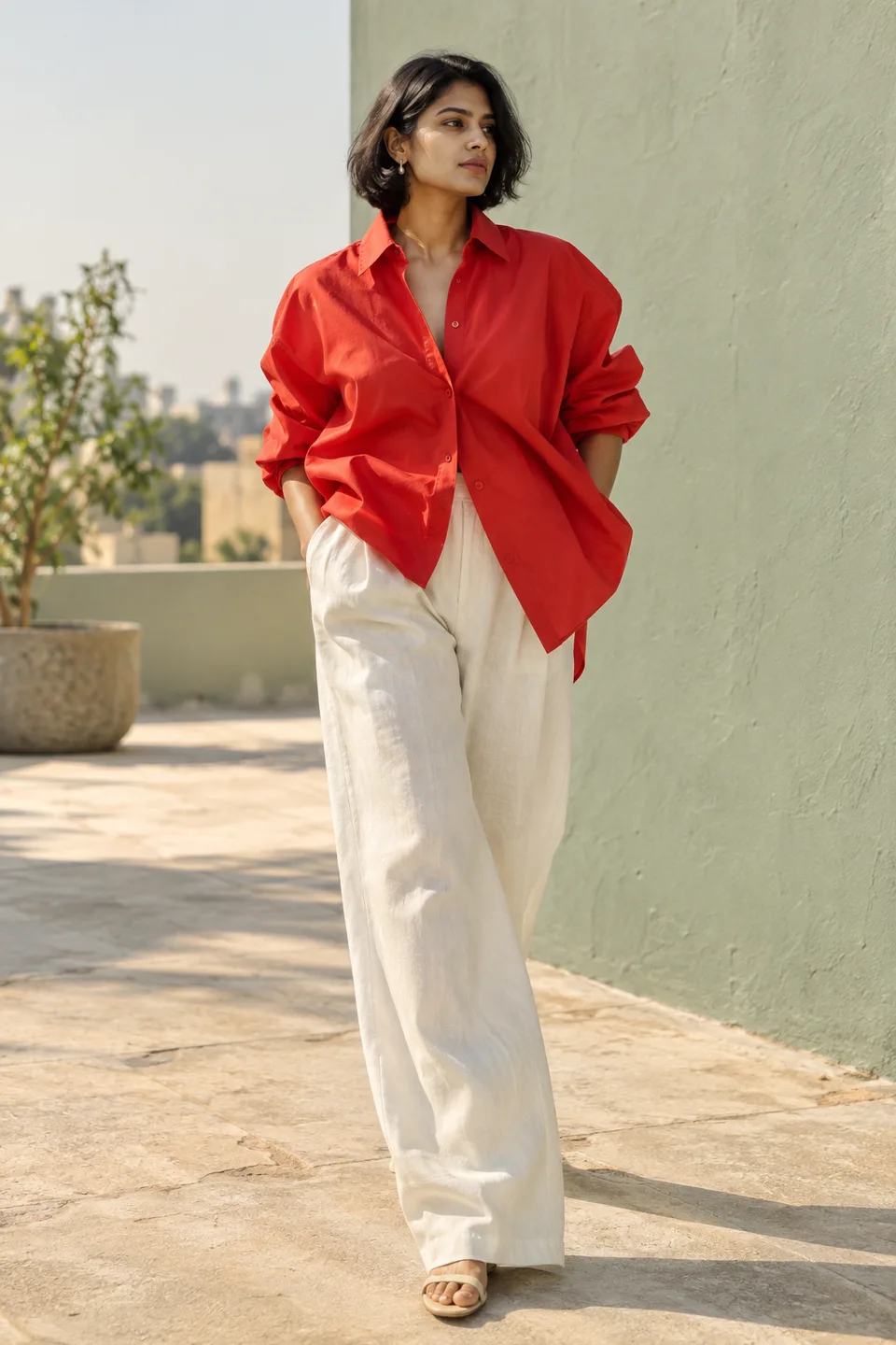 AI-generated fictional fashion creator in a red shirt and ivory trousers